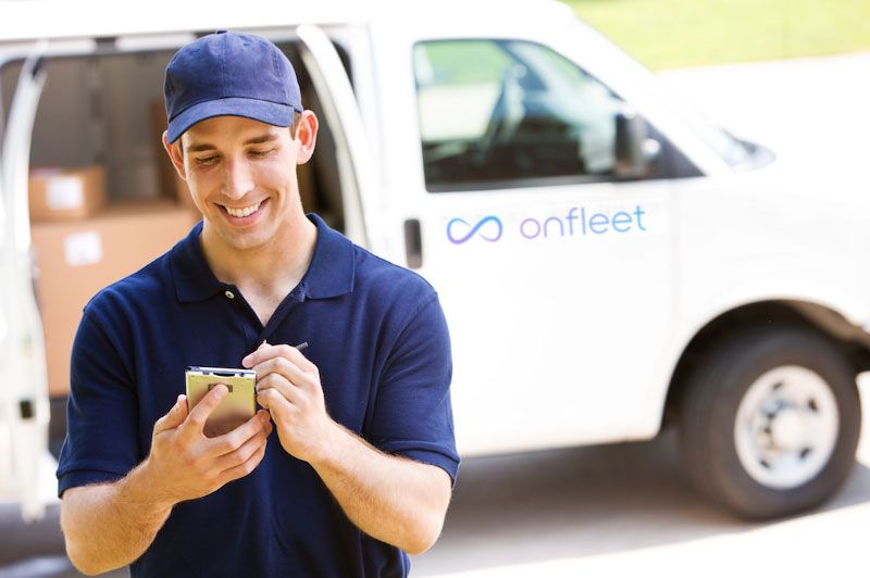 A delivery driver sends a customer a text message through the Onfleet app