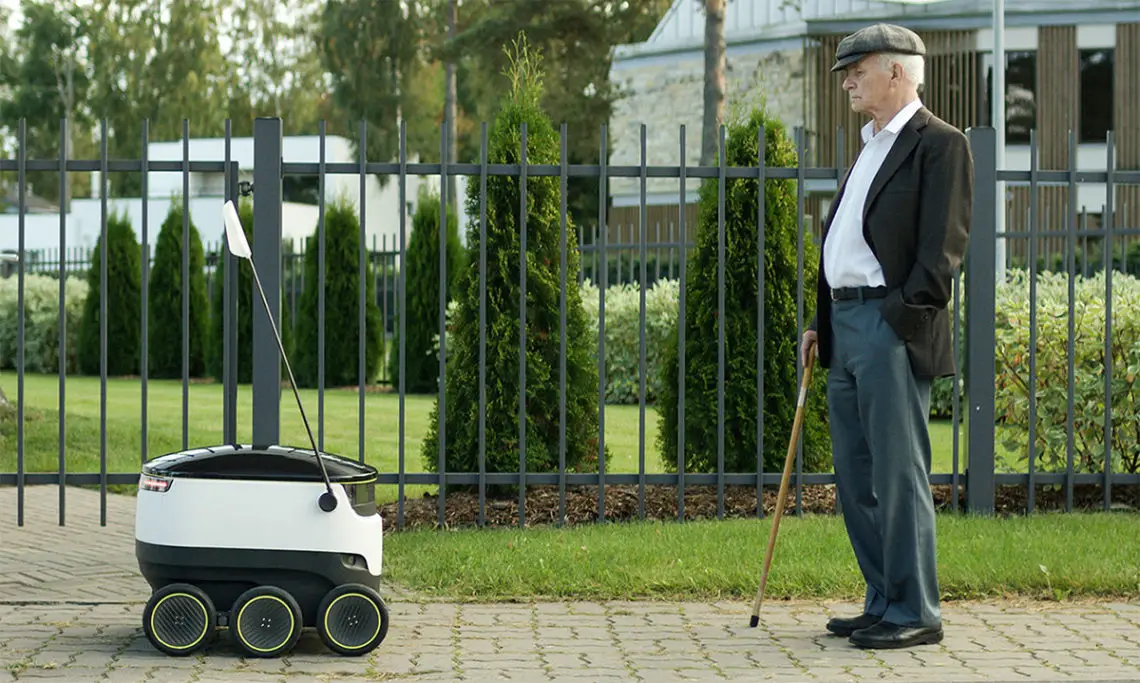 Starship Technologies' small autonomous delivery robot on a sidewalk